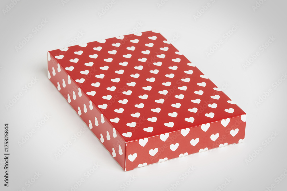 red gift box with hearts in white floating in a grey background red gift box with hearts in white floating in a grey background