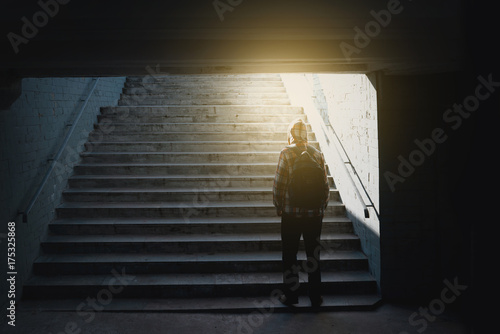 Loneliness man standing back in subway underground crossing photo