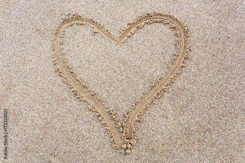 Heart drawn in the sand from above