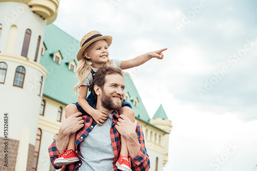 father and daughter piggybacking together