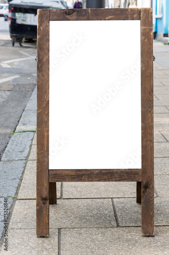 Blank ad space on wooden stand in the street