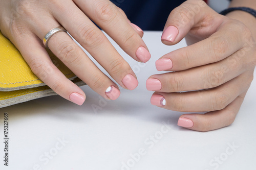 Natural nails with gel polish applied. Ideal manicure and women's hands.
