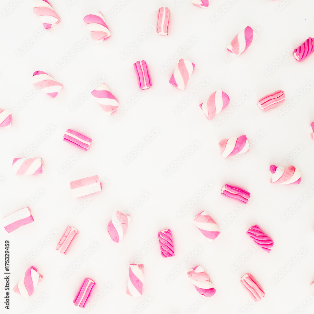 Candy pattern of pink marshmallow on white background. Sugary concept. Flat lay, top view