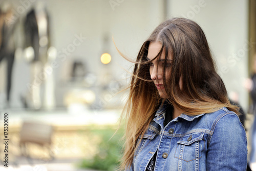 Tableau sur toile Trendy young hipster woman is looking down sadly with a blowzy hair