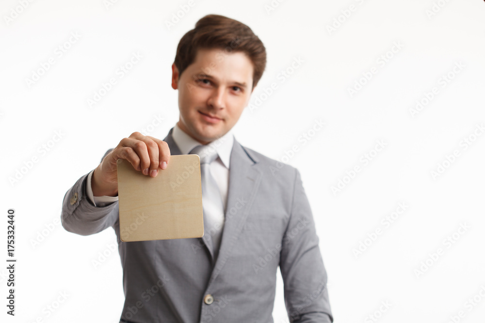 Young businessman showing signboard, isolated on white. Young businessman showing signboard, isolated on white.