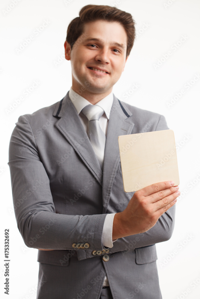 Young businessman showing signboard, isolated on white. Young businessman showing signboard, isolated on white.