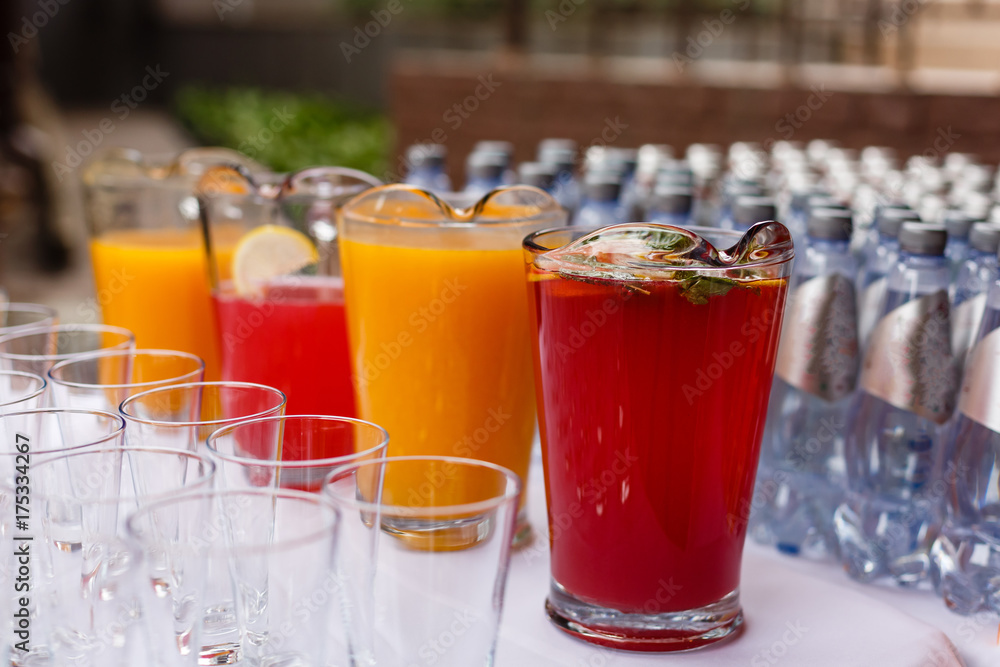 food background. many glasses with natural juice with orange on buffet table food background. many glasses with natural juice with orange on buffet table