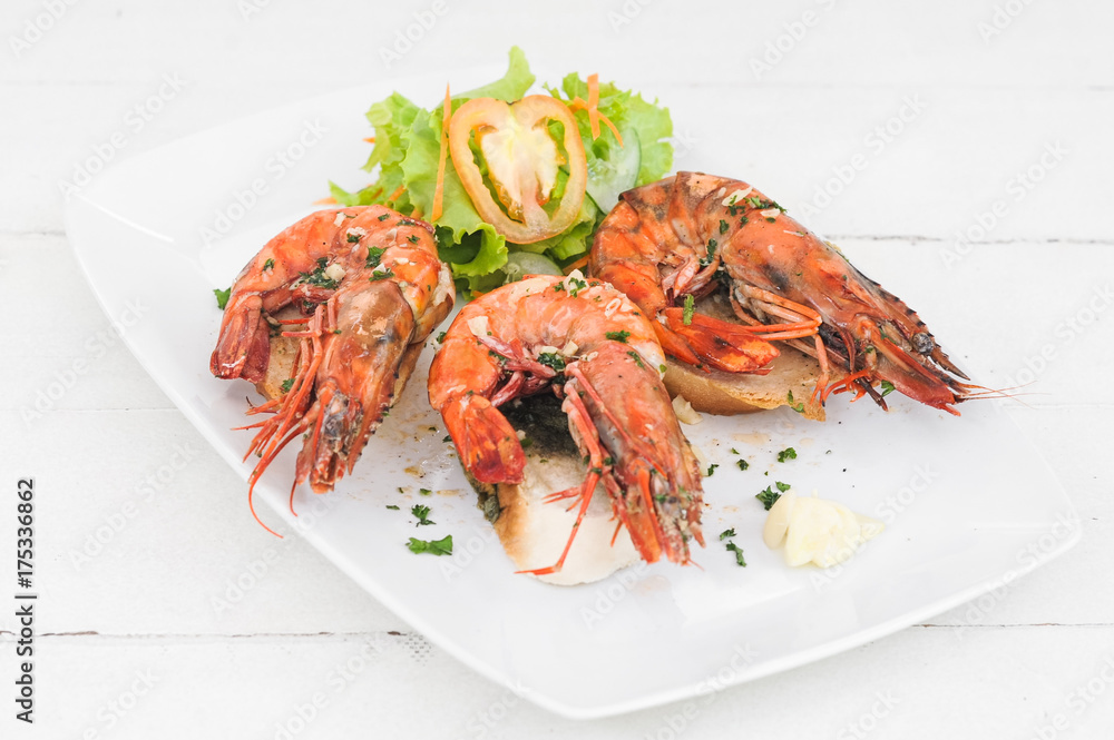 Prawn dish on the toasted bread with salad and garlic Prawn dish on the toasted bread with salad and garlic