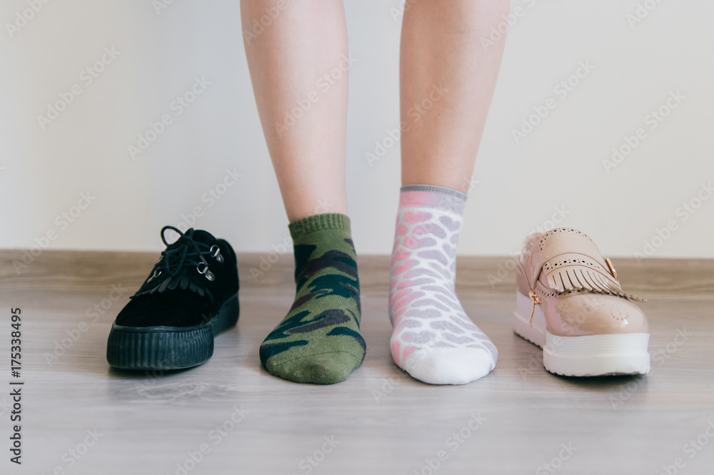 Female naked legs standing on floor. Women`s feet in missmatched cotton  socks. Odd unusual weird unrecognizable bizarre kinky girl. Brutal and  tenderness concept. Different big choice of footwear. Stock Photo | Adobe