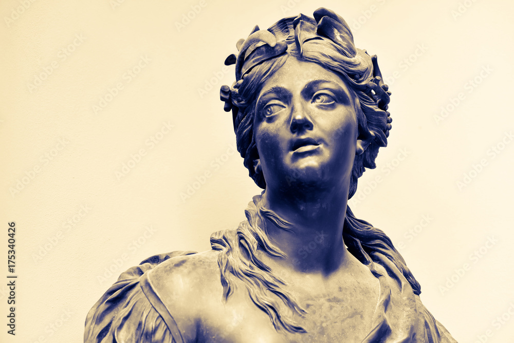 Ancient female statue of 18th century outdoor in park. Public domain. Nymph with a hoop of