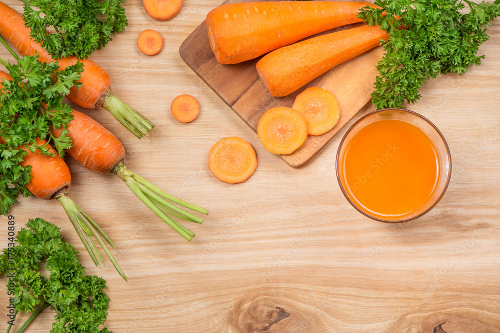 Glass of fresh carrot juice with vegetables on wooden table. Glass of fresh carrot juice with vegetables on wooden table.