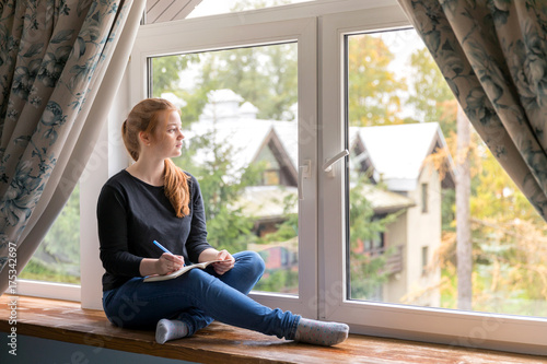 Free Download Girl sitting at the window and dreaming about your life with notes - GFXLoad