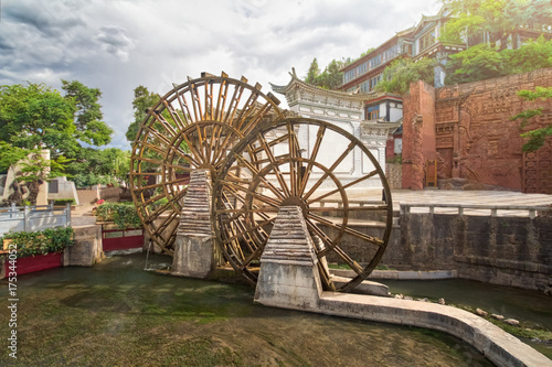 Water wheel is a symbol of Lijiang old town , the World Heritage Site in 1997 , Yunnan, China.