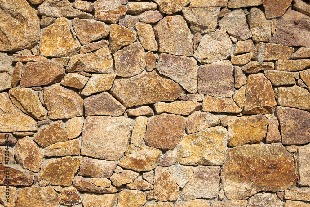 Old beige big stone wall background texture close up Old beige big stone wall background texture close up