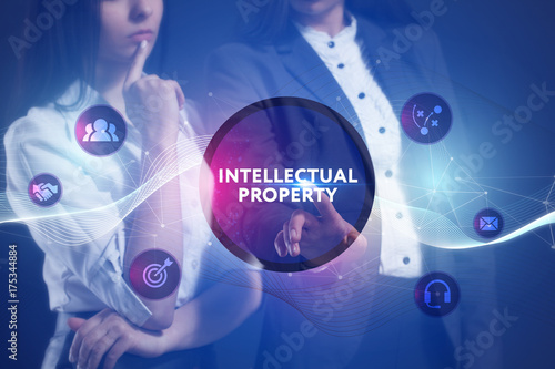 The concept of business, technology, the Internet and the network. A team of business women working on the virtual screen of the future and see the inscription: Intellectual property