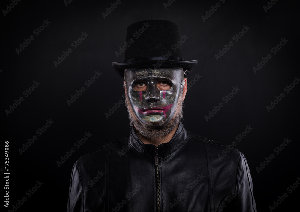 Mystery man holding black mask. Anonymous social masking concept. Mystery man holding black mask. Anonymous social masking concept.