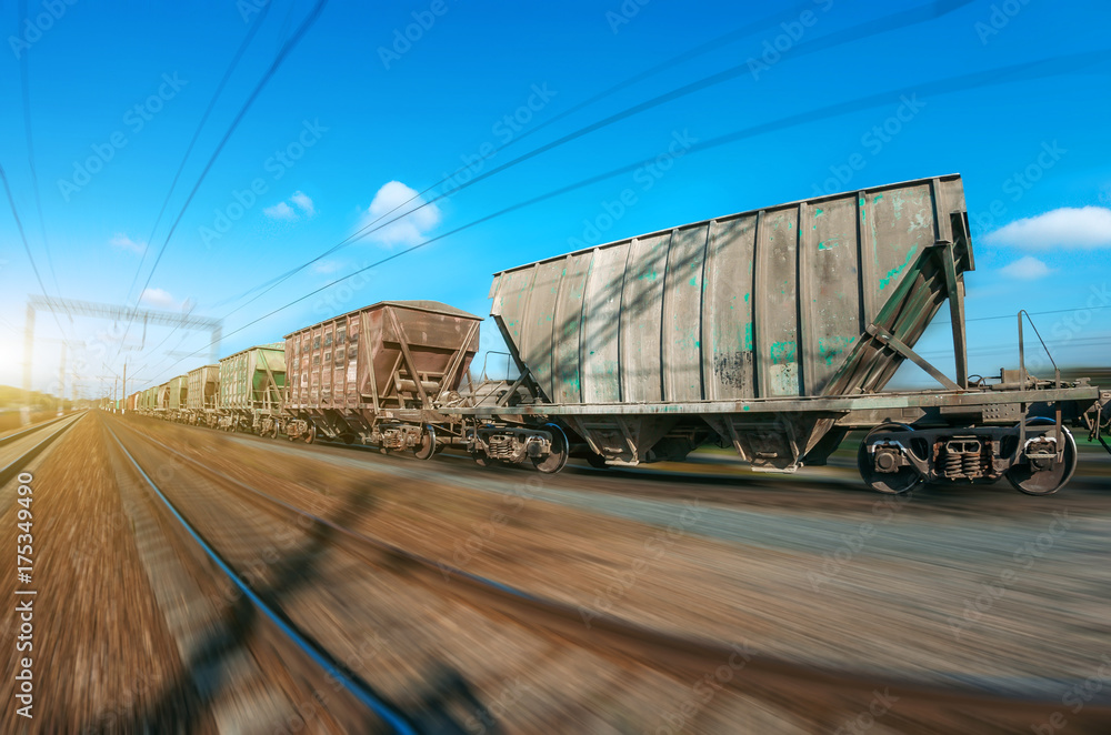 Obraz premium The railway hopper car for the transportation rail road train in motion at speed.