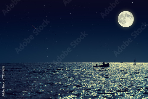 Scenic view of small fishing boat in calm sea water at night and full moon