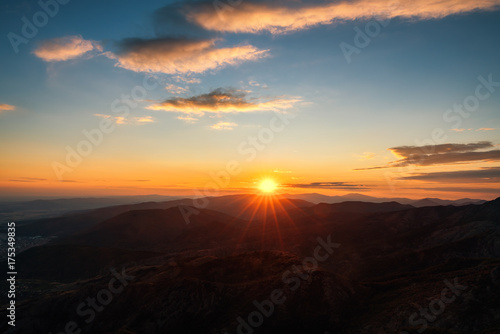 Colorful sunset on top of mountain alps