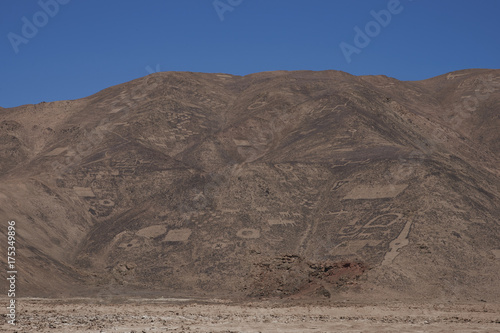 Large group of ancient petroglyphs on the hillsides at Cerro Pintados in the Atacama Desert in the Tarapaca Region of northern Chile. 