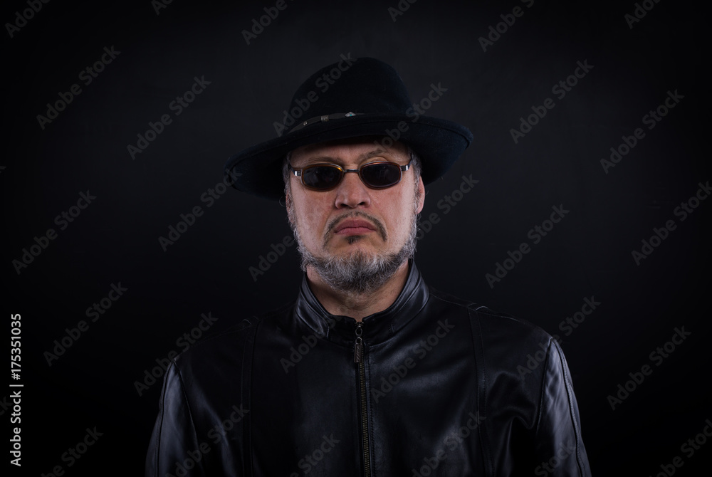 studio portrait of a man in a black winter hat studio portrait of a man in a black winter hat