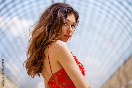 Beautiful brunette woman in red dress