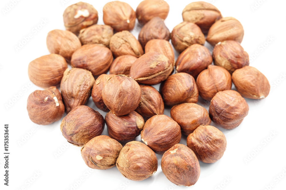Raw hazelnut on heap, isolated on white background Raw hazelnut on heap, isolated on white background