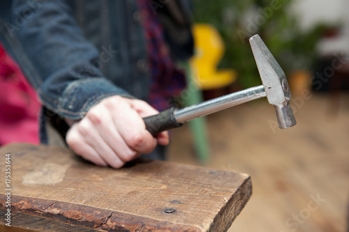 man's hand holding a hammer