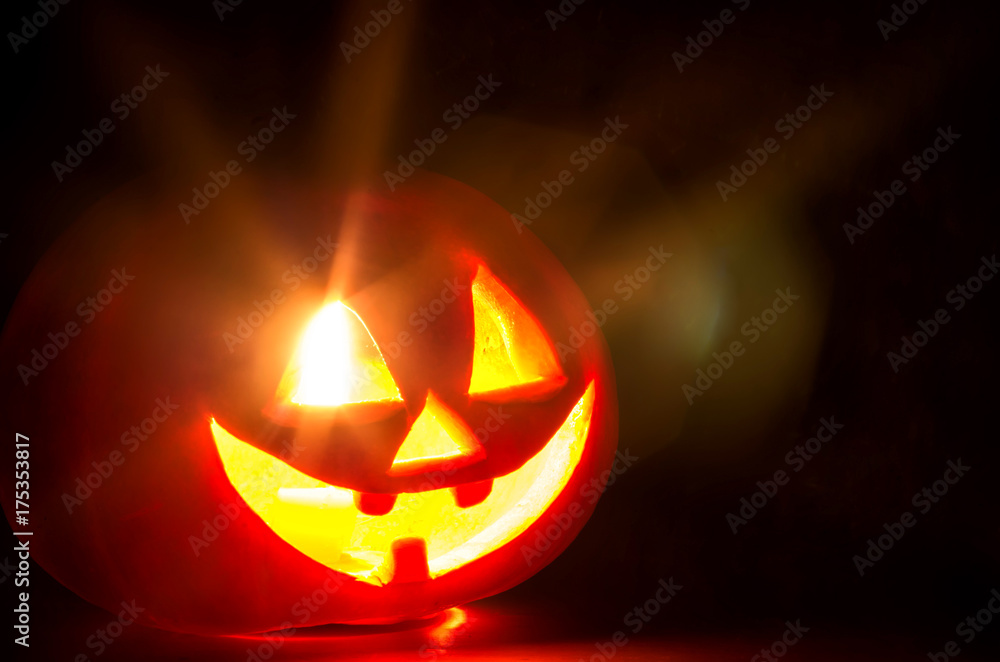 Fototapeta premium spooky halloween pumpkin with candles and shiny eye