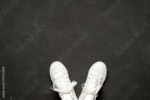 Stylish flat lay Of White Sneakers On black Background
