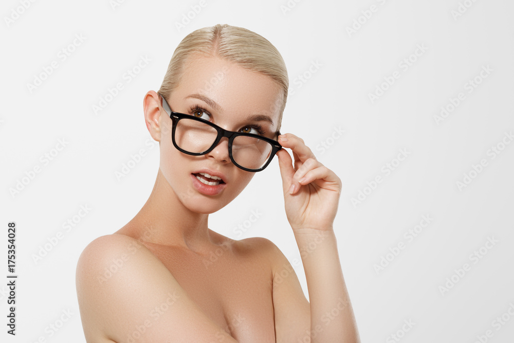 The concept of business and learning. A nice smiling blond girl with black glasses. Hipster. Young fashion and beauty model The concept of business and learning. A nice smiling blond girl with black glasses. Hipster. Young fashion and beauty model