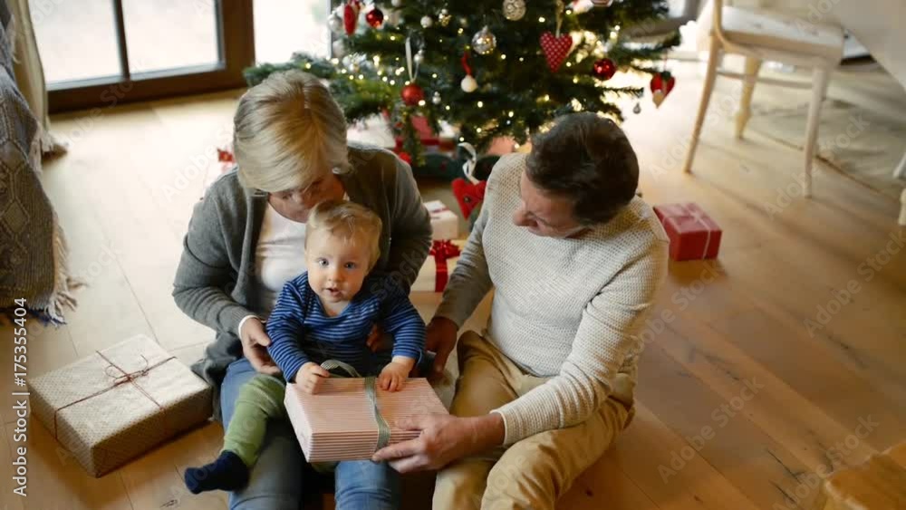 Grandparents with grandson at Christmas tree at home. Grandparents with grandson at Christmas tree at home.