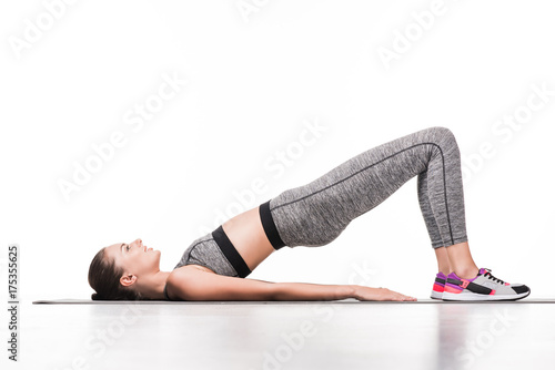 Fototapeta Naklejka Na Ścianę i Meble -  sportswoman exercising on yoga mat