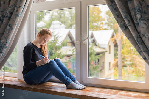Girl sitting at the window and dreaming about your life with notes Free Download Girl sitting at the window and dreaming about your life with notes - GFXLoad