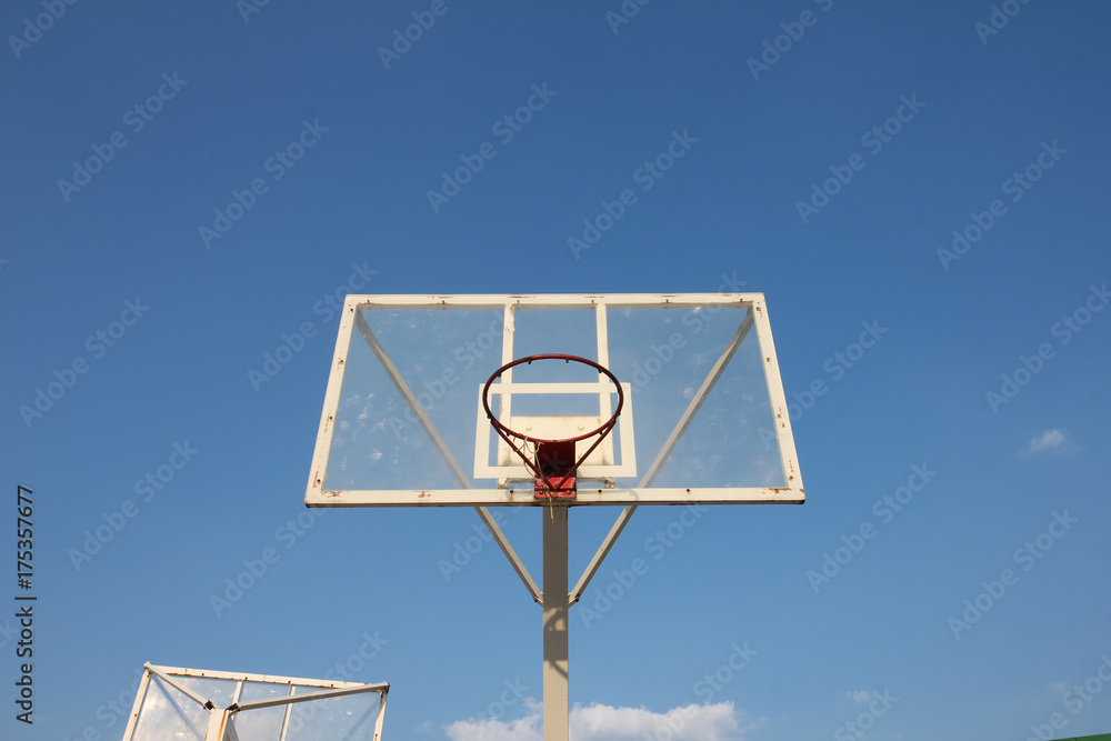 Naklejka premium Basketball basket with transparent backboard on beautiful sky