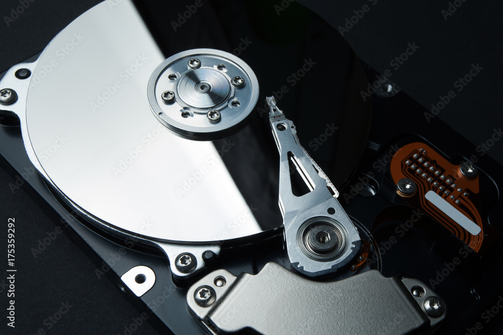Protection of data and personal information on the Internet. Hard disk and a recording head on a black background. Protection of data and personal information on the Internet. Hard disk and a recording head on a black background.