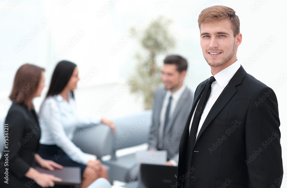 portrait of confident businessman on background of office. portrait of confident businessman on background of office.