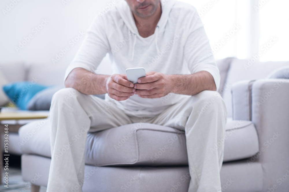 young man using a mobile phone  at home
