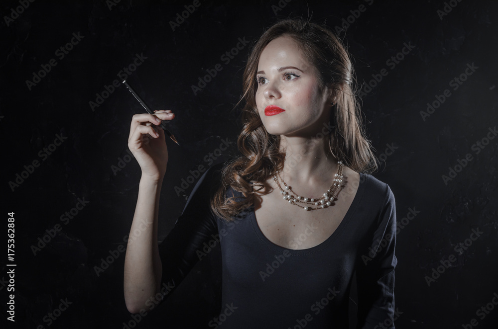 Obraz premium Noir film style woman in dress holding cigarette. Black and white photography. Old fashion photo