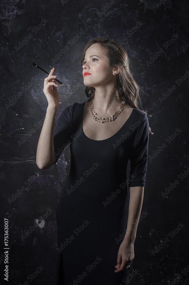Obraz premium Noir film style woman in dress holding cigarette. Black and white photography. Old fashion photo