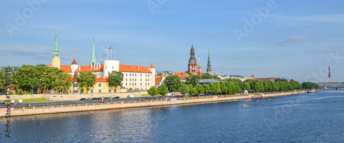 Riga, Latvia - August 23, 2017: Beautiful early morning cityscape of the old town of Riga, St Peter's Church Tower and Daugava river, Latvia. Panorama of old city center and beautiful river, Riga.