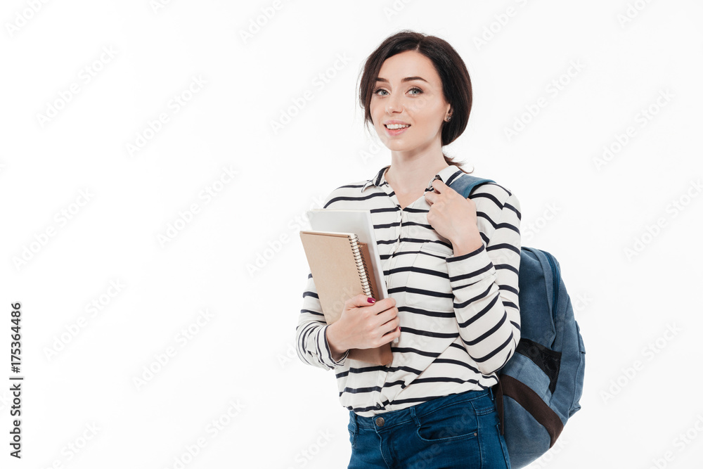 Portrait of a pretty teenage girl with backpack holding books Portrait of a pretty teenage girl with backpack holding books