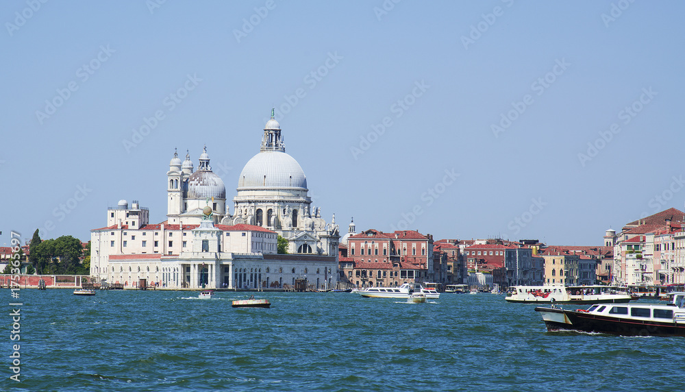 Grand Canal and Basilica Santa Maria della Salute in Venice on a bright day.