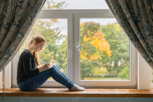 Girl sitting at the window and dreaming about your life with notes Free Download Girl sitting at the window and dreaming about your life with notes - GFXLoad