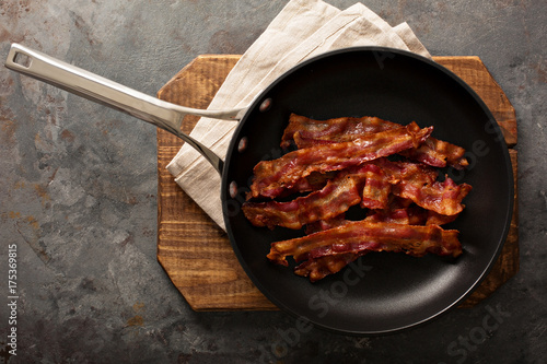 Cooked bacon on a skillet photo