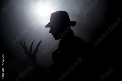 the man in the hat in the dark