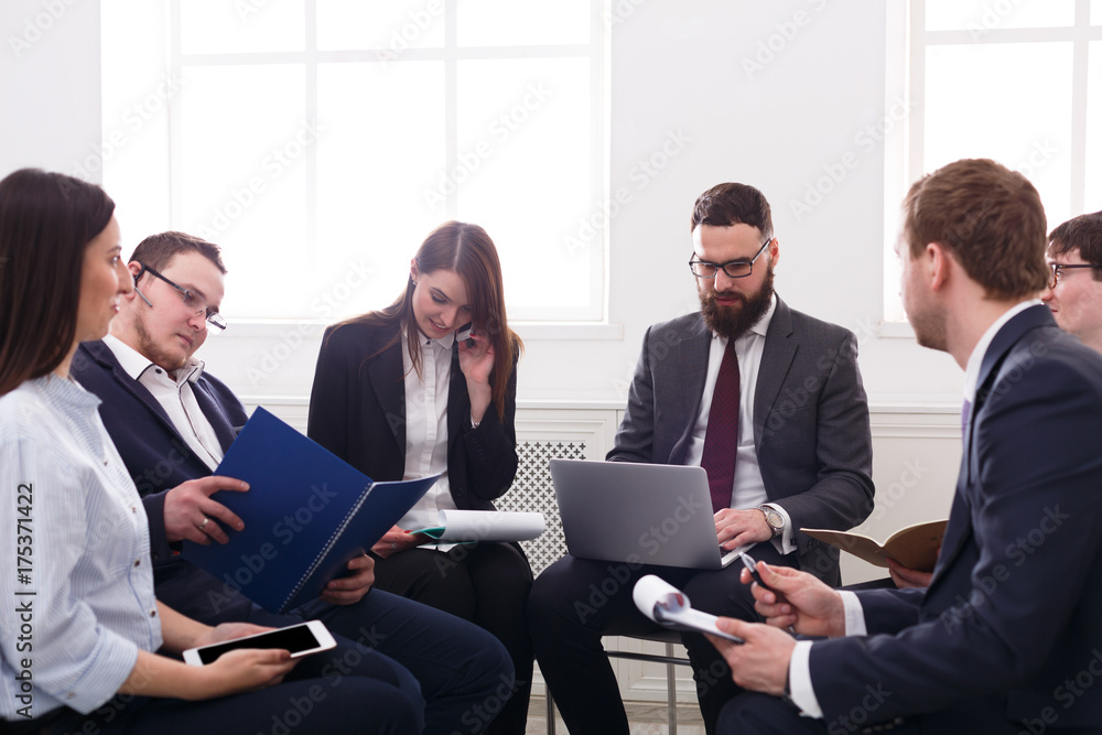 Business meeting. Managers male and female at modern office, team friendly discussion at workplace. Office life.