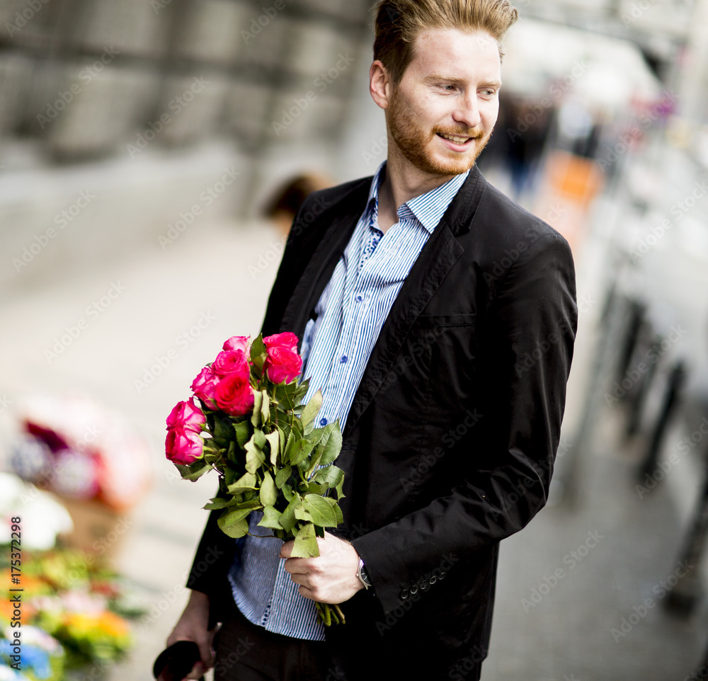 Man standing with a bouquet on the street Man standing with a bouquet on the street