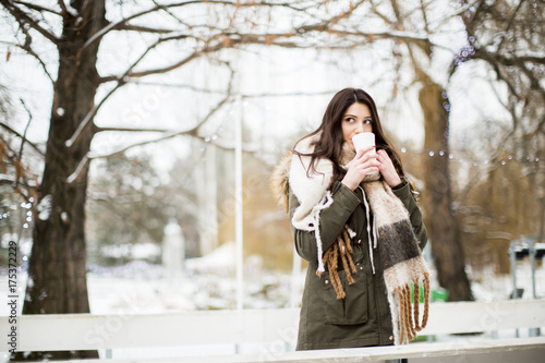Pretty young woman drinking...