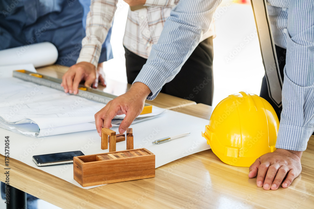 Team engineers working with construction tools on table Team engineers working with construction tools on table